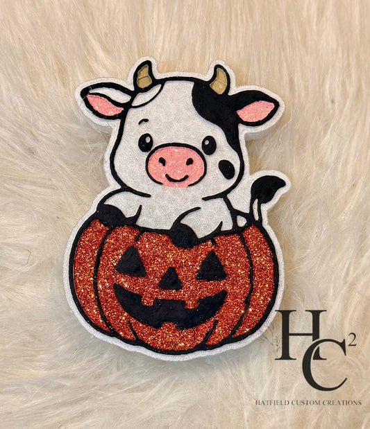 Cute cow in pumpkin