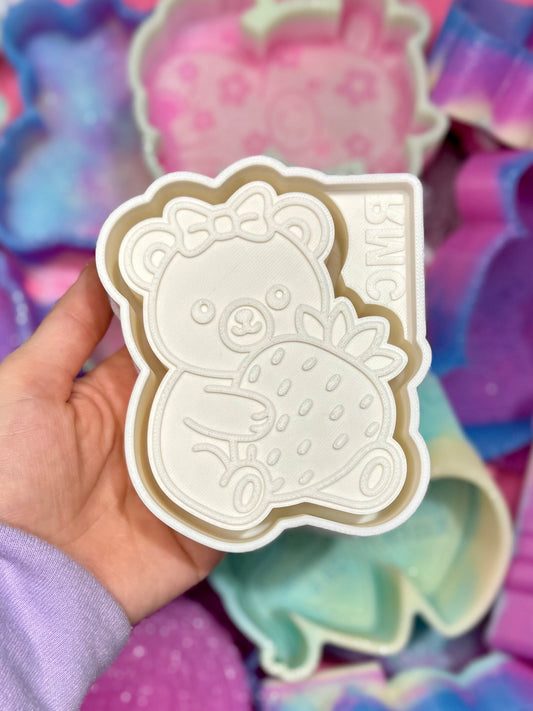 Bear holding strawberry